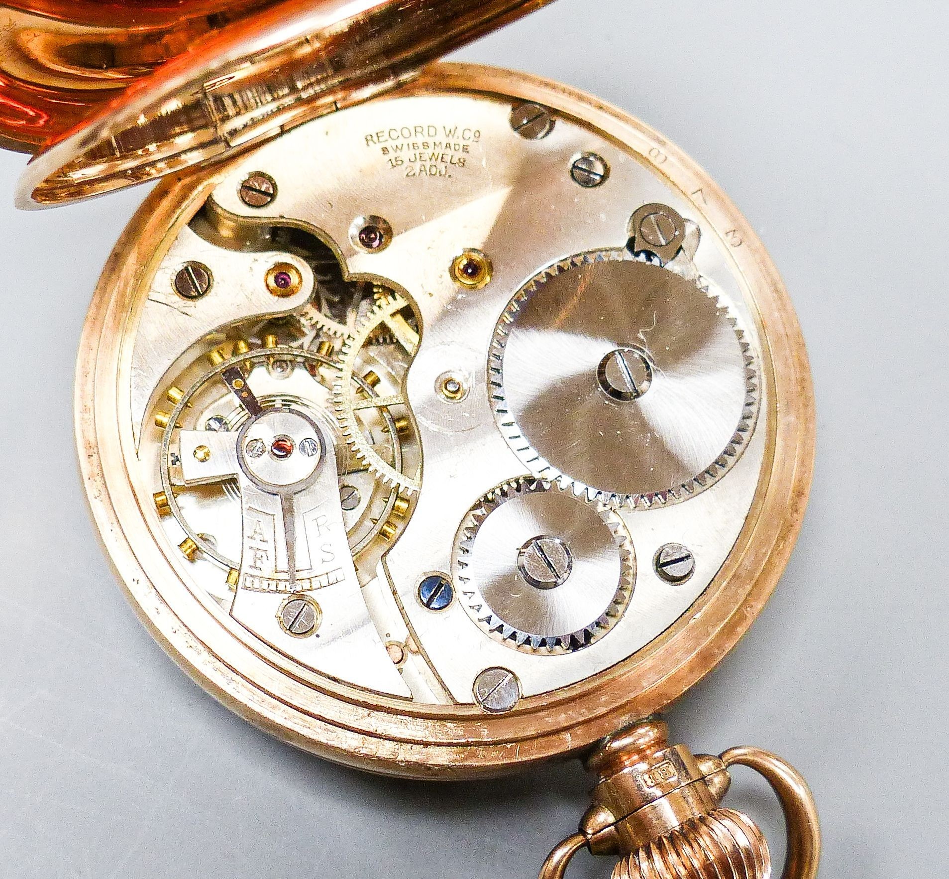 An early 20th century Swiss 9ct gold open faced keyless pocket watch, movement signed Record W. Co, case diameter 48mm, gross weight 77.6 grams.